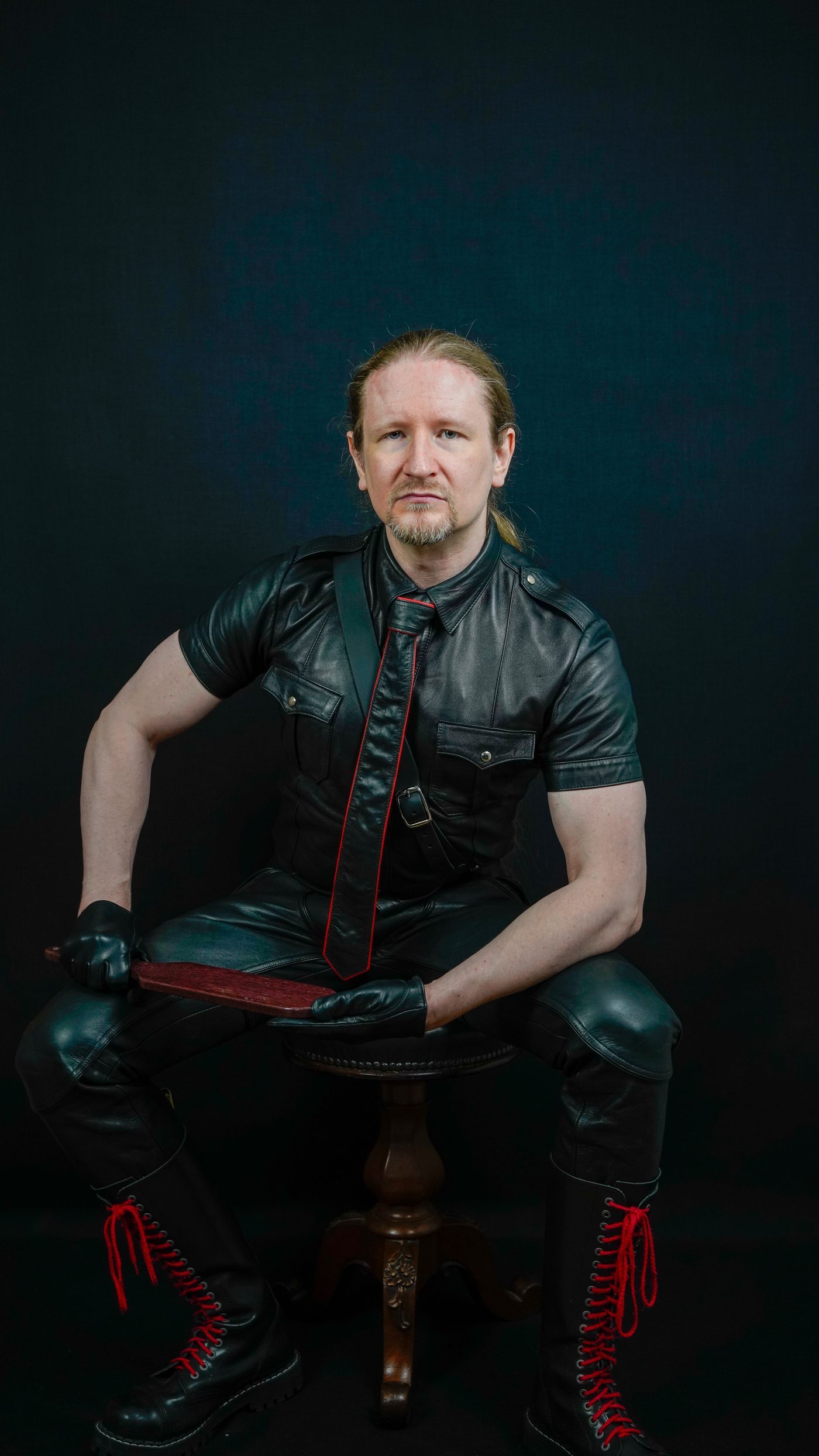 Master Samael seated in leather