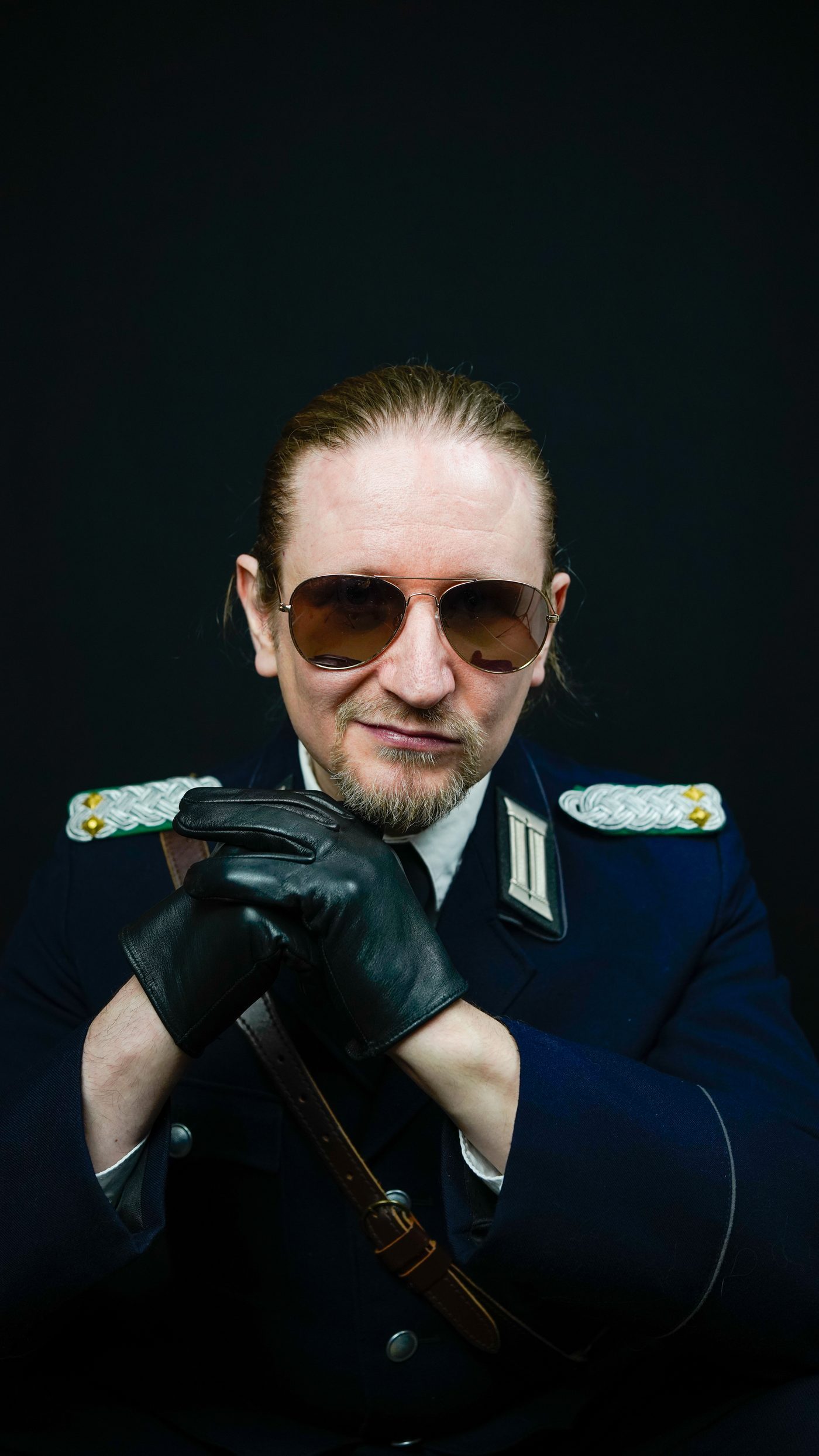 Master Samael in aviators and leather gloves